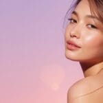 AI-generated beauty portrait of an Asian woman with glowing skin positioned to the right side of the frame with large empty lavender to pink gradient space on the left for Instagram reel cover text overlay
